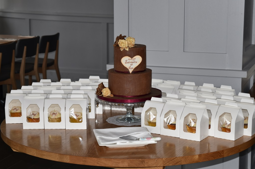 A Perfect Bakes wedding cake with separate cupcakes for each guest.
